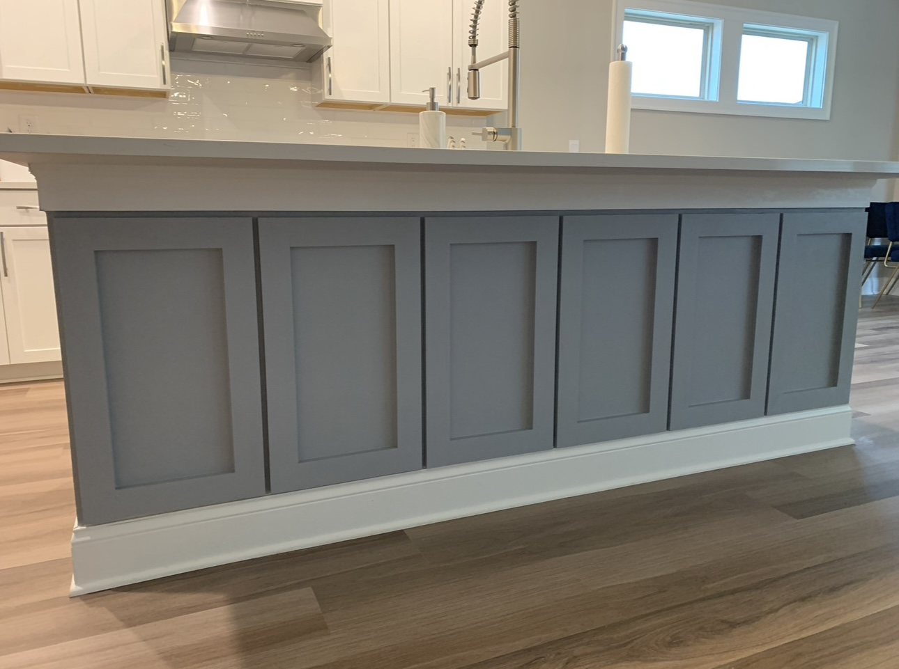 Blue kitchen island with paneling