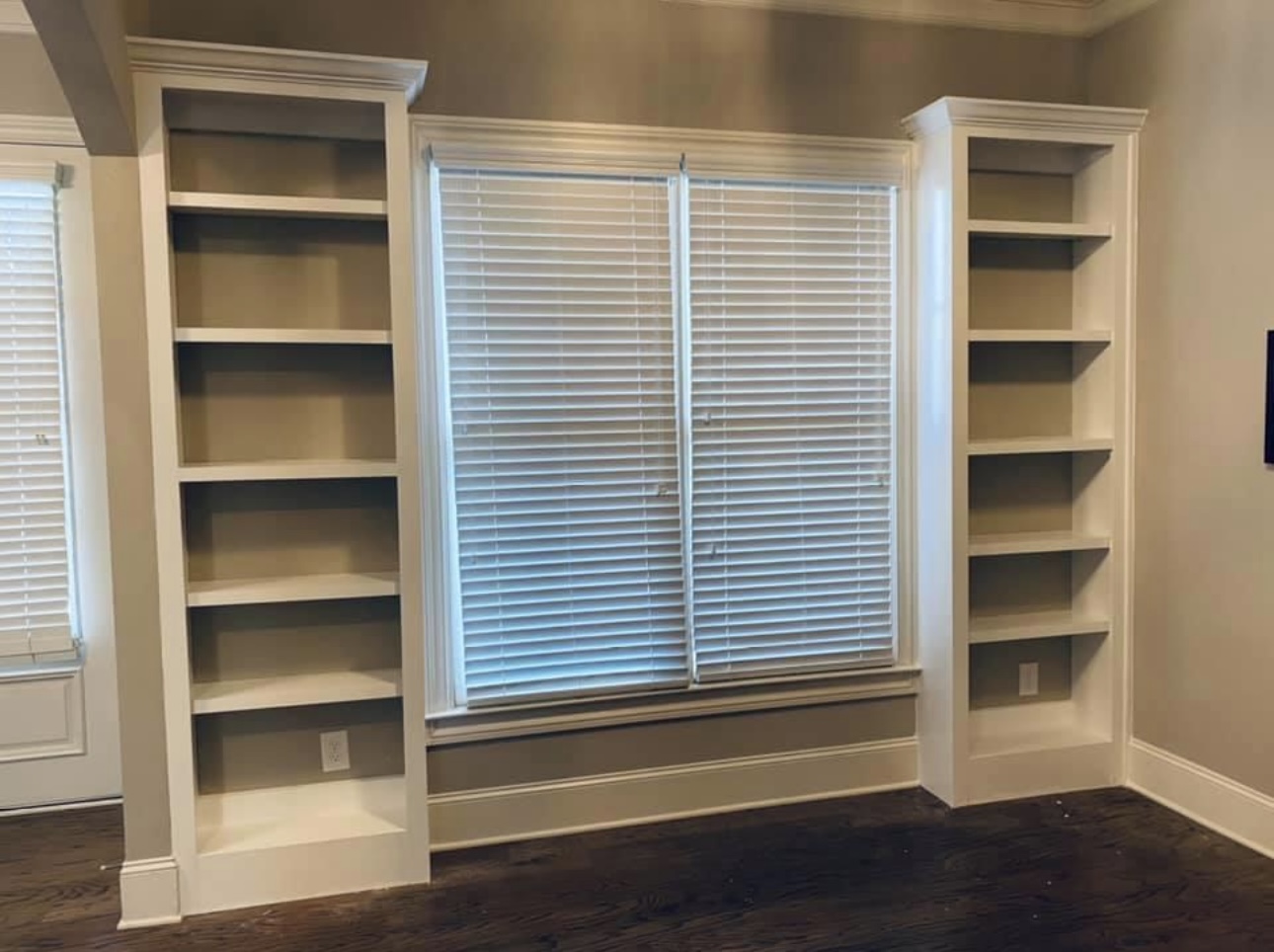 Twin shelves flanking window