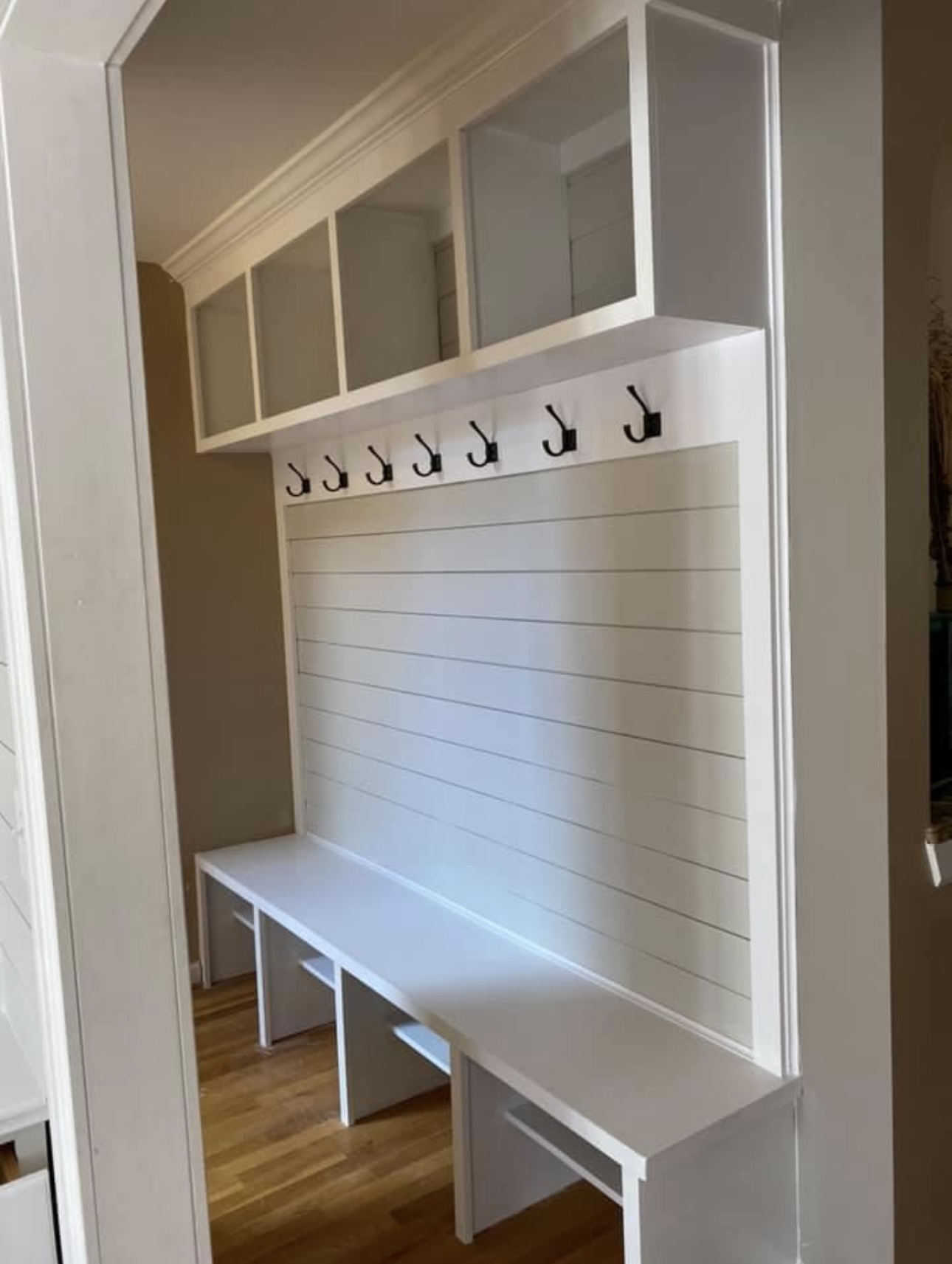 Mudroom with coat hangers and bench