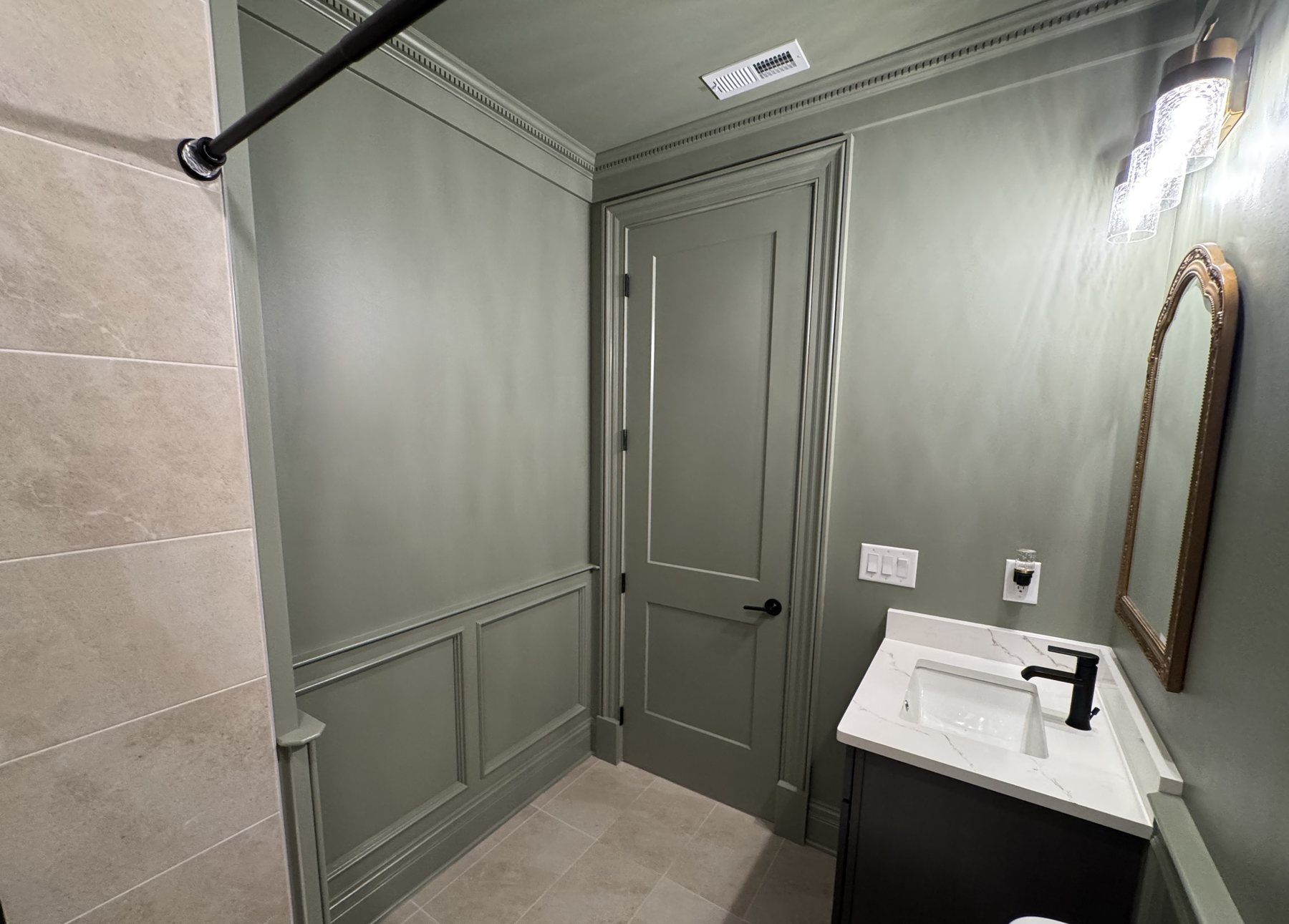 Wainscoting running into the door casing beside the vanity