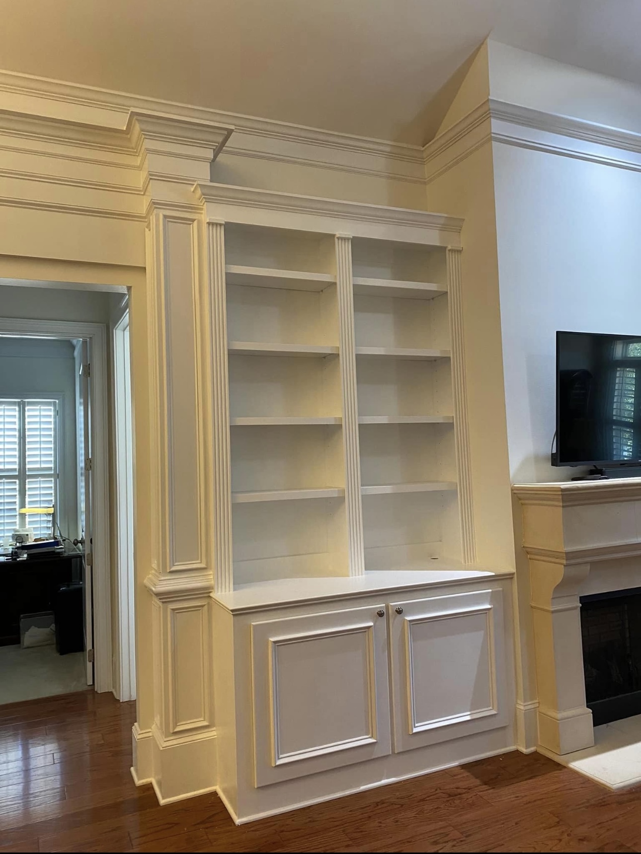 Full wall white bookshelves